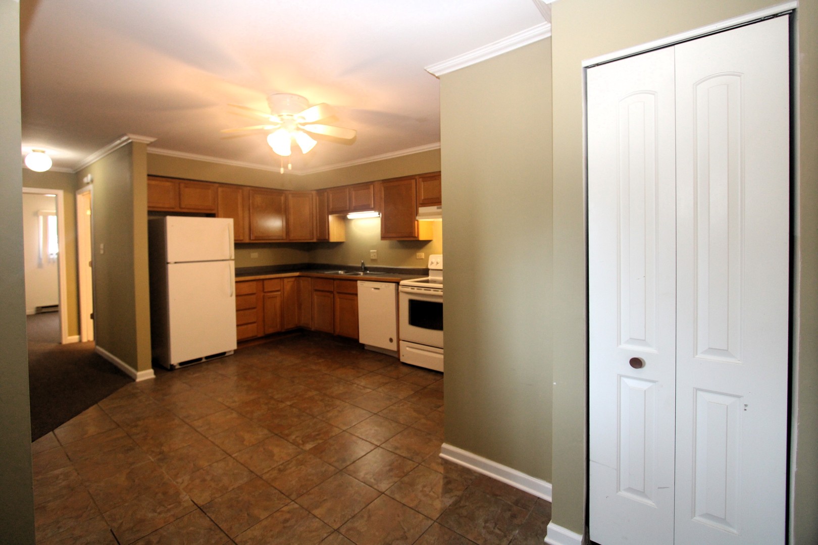 212 Madison Street, Unit 1B Joliet, IL 60435 - Photo 8 of 21 a kitchen with stainless steel appliances a refrigerator and a sink