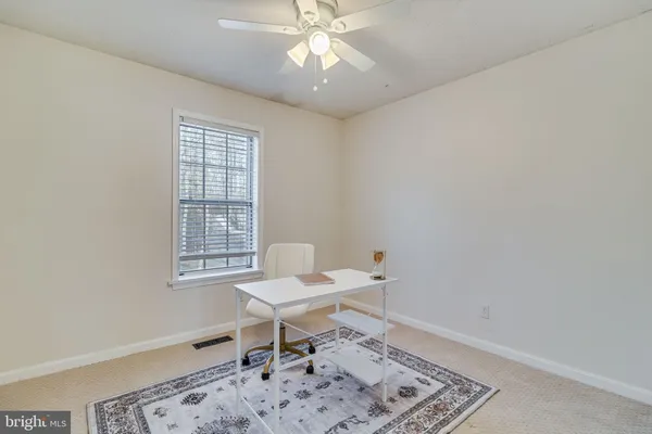 a work room with a window and ceiling fan