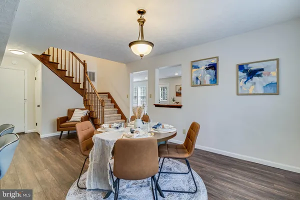 a view of a dining room with furniture wooden floor and a chandelier