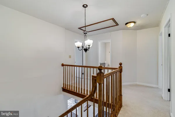 a view of a hallway with a chandelier