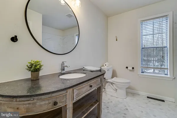a white bath tub sitting next to a toilet