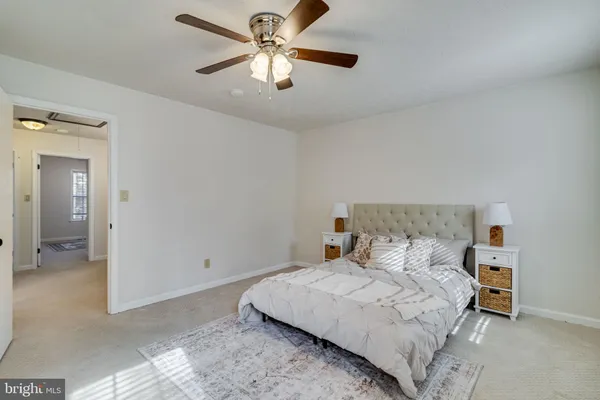 a view of a bedroom with a bed and hallway