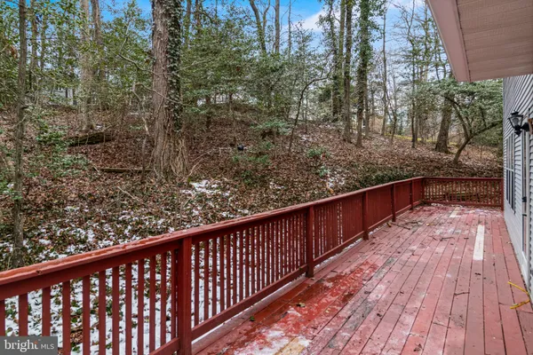 a balcony with wooden floor and trees