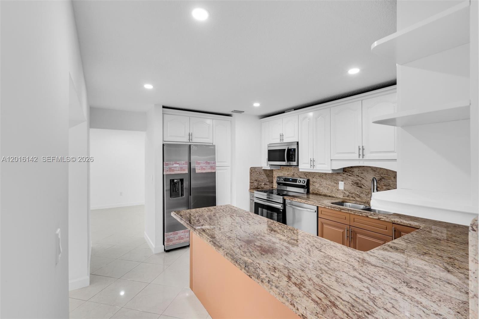 14755 Southwest 82nd Terrace Miami, FL 33193 - Photo 11 of 32 a large kitchen with cabinets wooden floor and stainless steel appliances