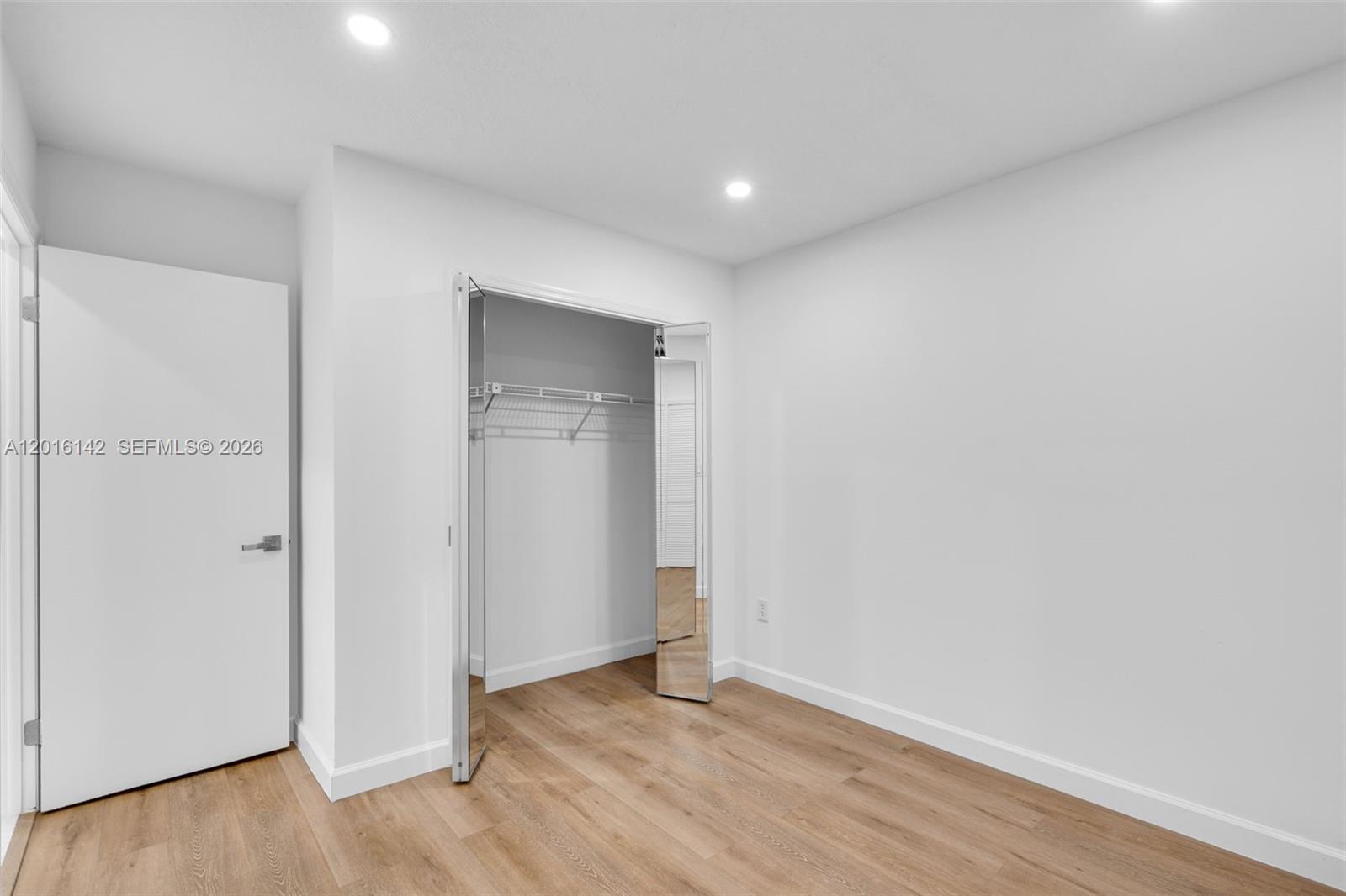 14755 Southwest 82nd Terrace Miami, FL 33193 - Photo 16 of 32 a view of an empty room with wooden floor and closet