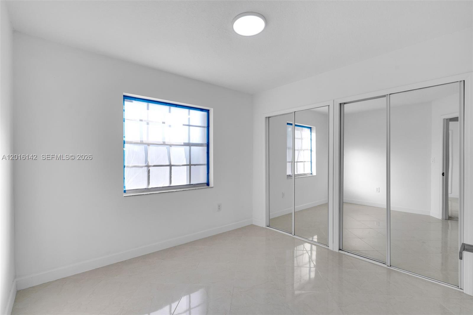 14755 Southwest 82nd Terrace Miami, FL 33193 - Photo 18 of 32 an empty room with windows and closet
