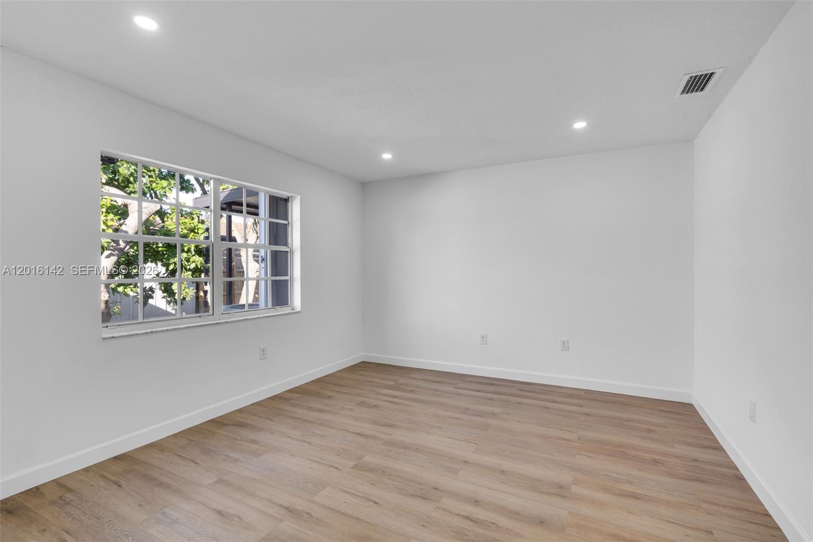 14755 Southwest 82nd Terrace Miami, FL 33193 - Photo 23 of 32 wooden floor in an empty room with a window