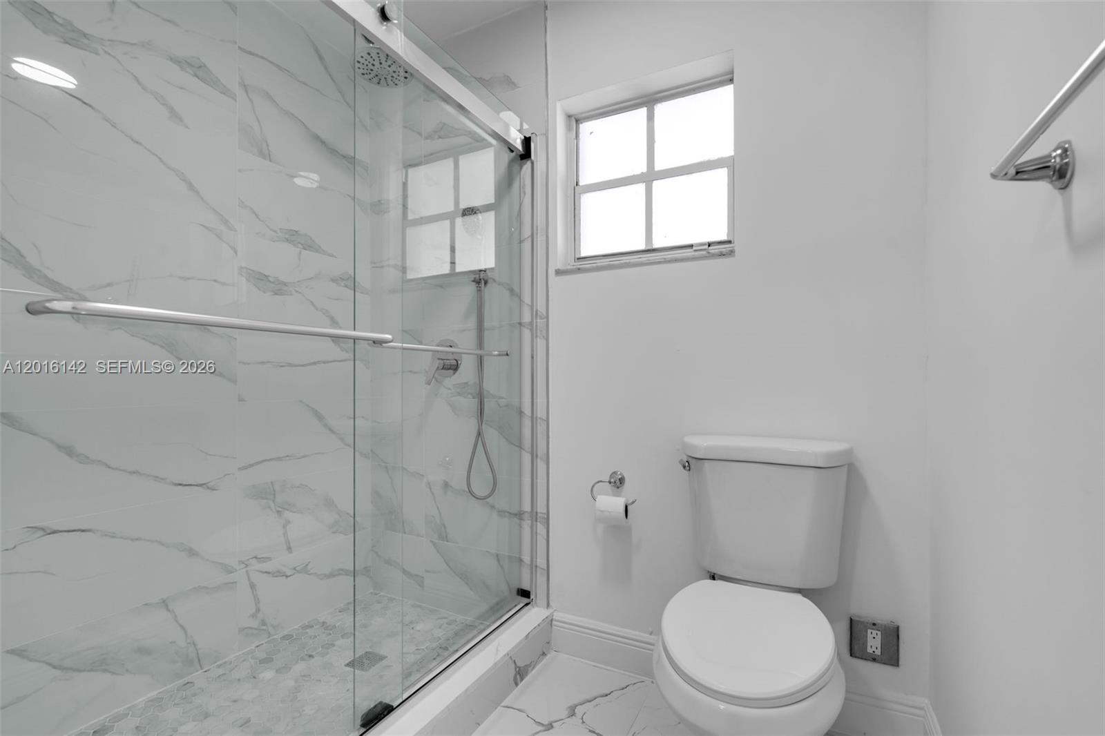 14755 Southwest 82nd Terrace Miami, FL 33193 - Photo 27 of 32 a white toilet sitting next to a bathroom sink