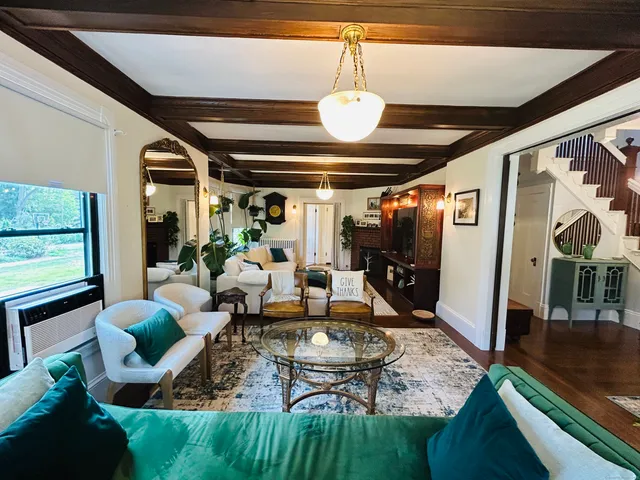a living room with lots of furniture and a chandelier