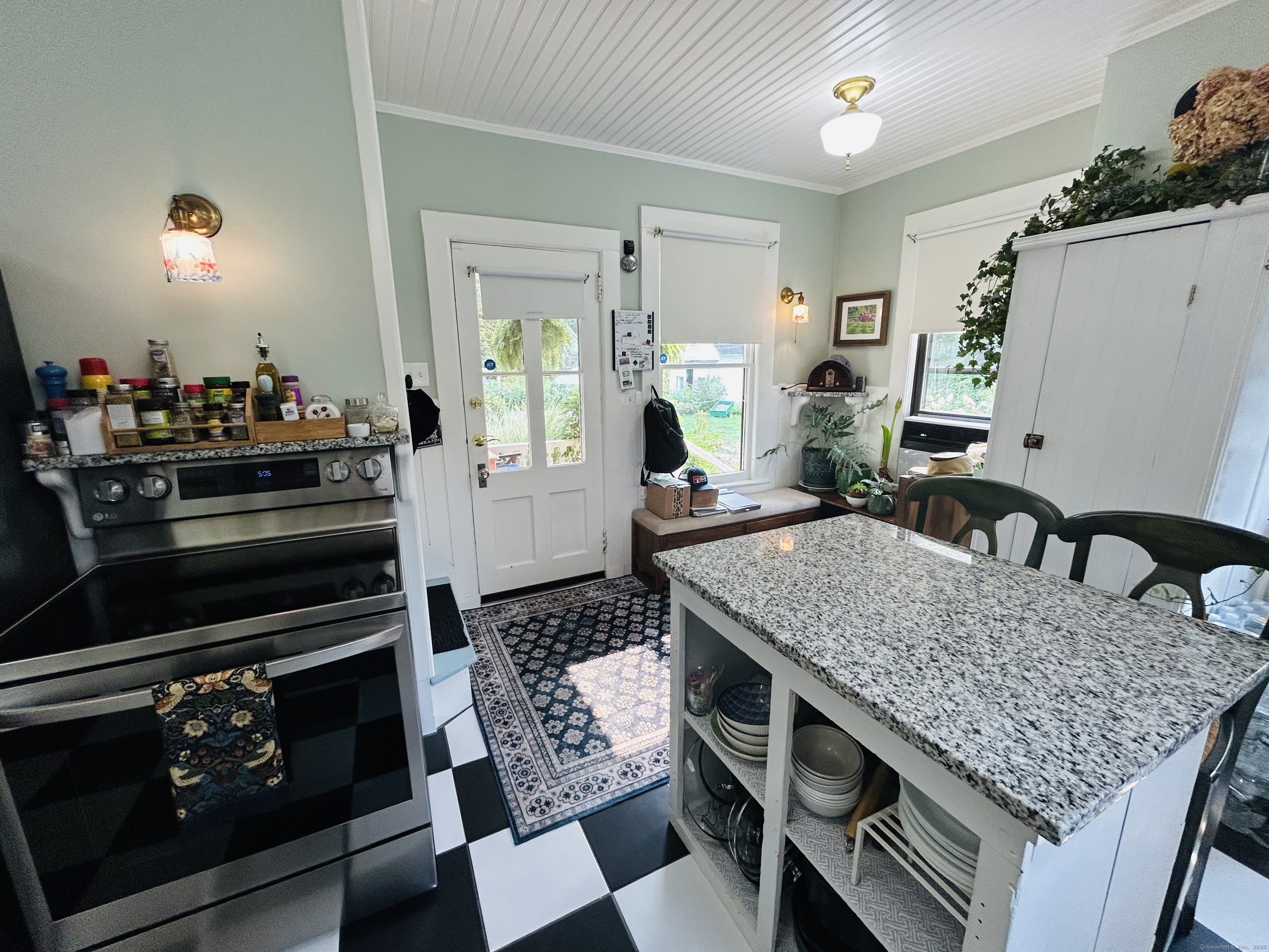 37 School Street Enfield, CT 06082 - Photo 8 of 15 a kitchen with a table chairs and a stove