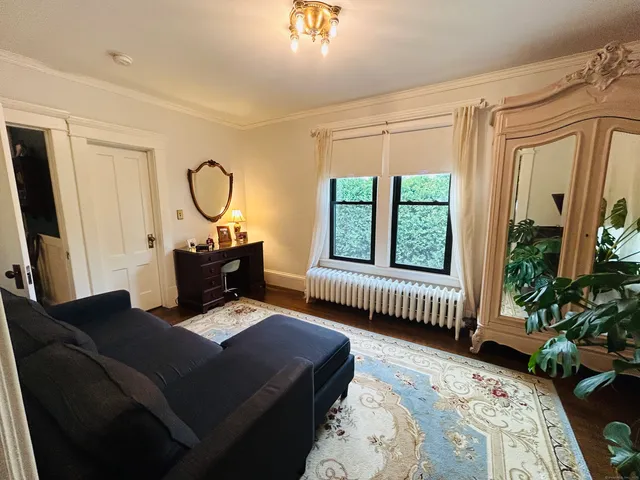 a living room with furniture lamp and a window