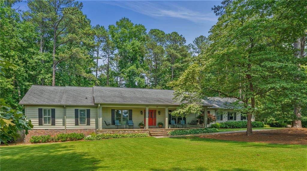 a front view of a house with a yard table and chairs