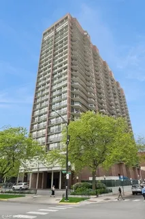 a view of a tall building next to a road