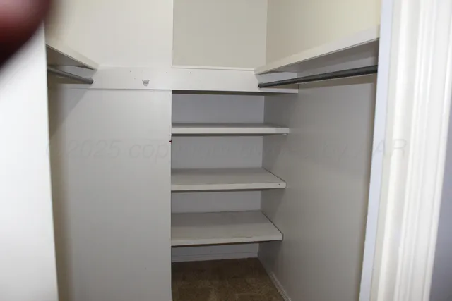 a view of an empty walk in closet