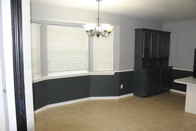 a view of a room with a large window and chandelier