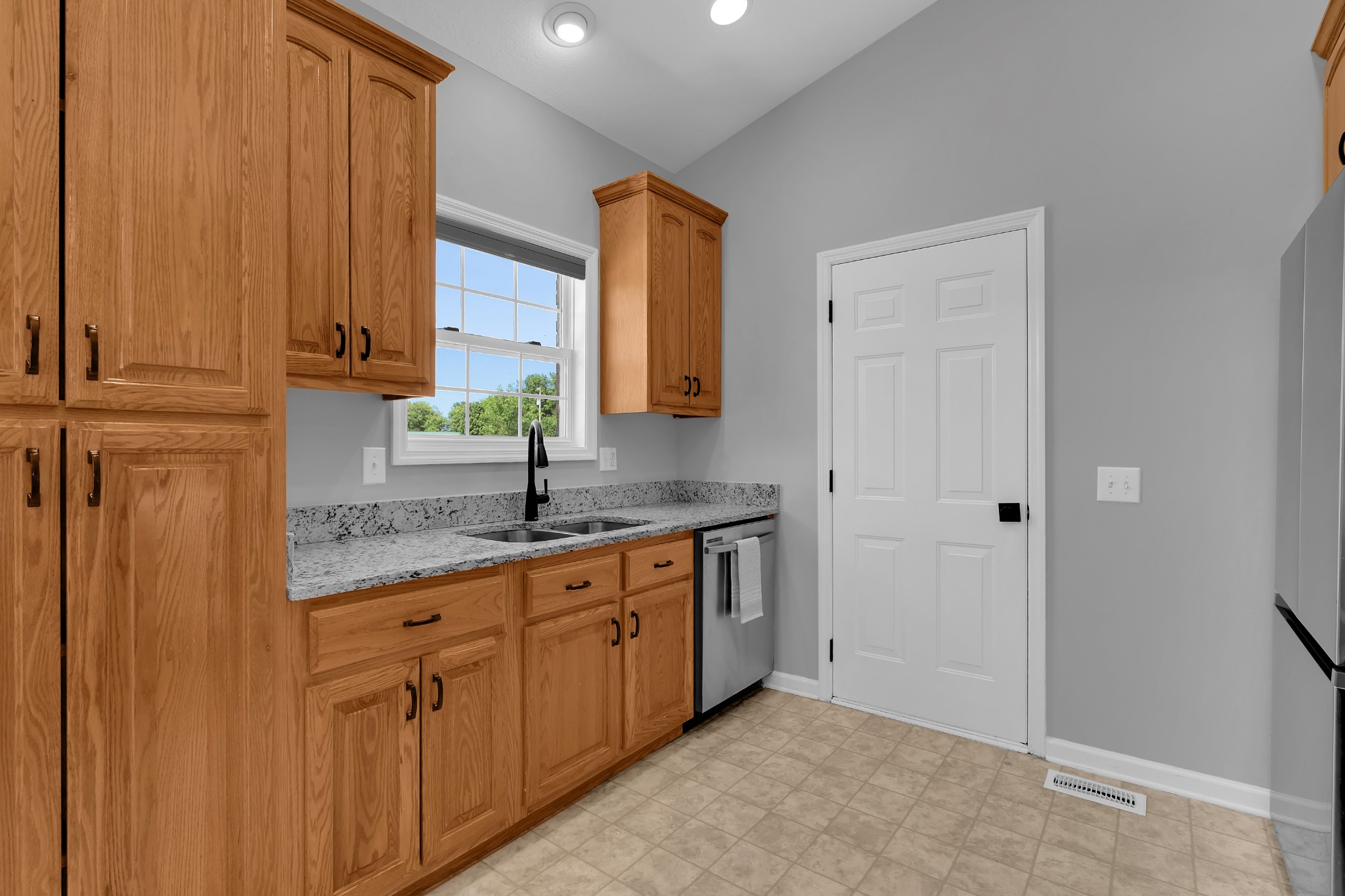 3896 Lynchburg Road Winchester, TN 37398 - Photo 15 of 57 a kitchen with stainless steel appliances granite countertop a sink and a refrigerator