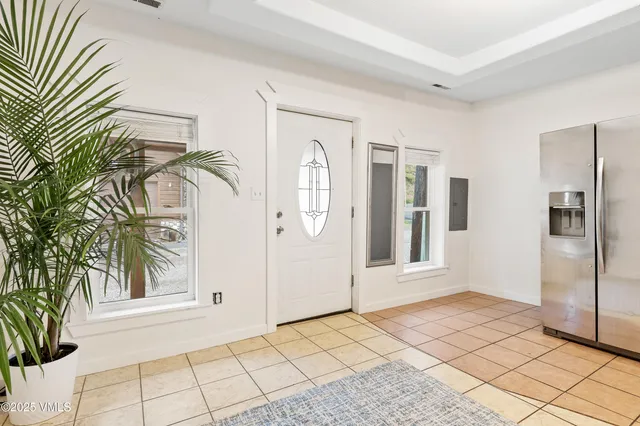 a view of a hallway with a window and a refrigerator