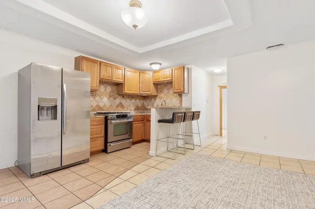 a kitchen with stainless steel appliances a refrigerator and a stove top oven