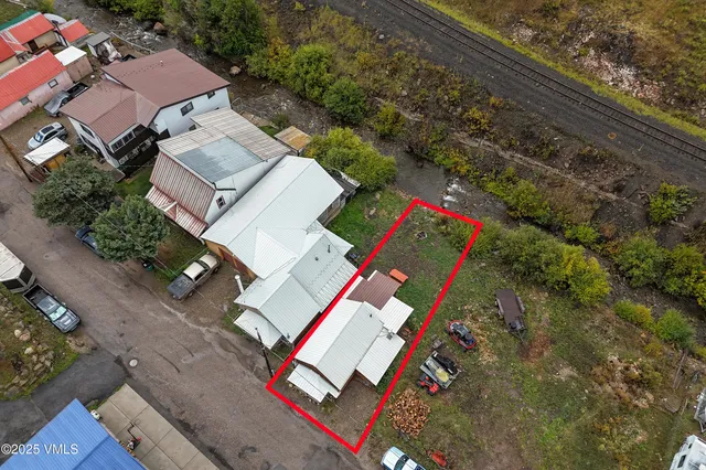 an aerial view of a house with a yard