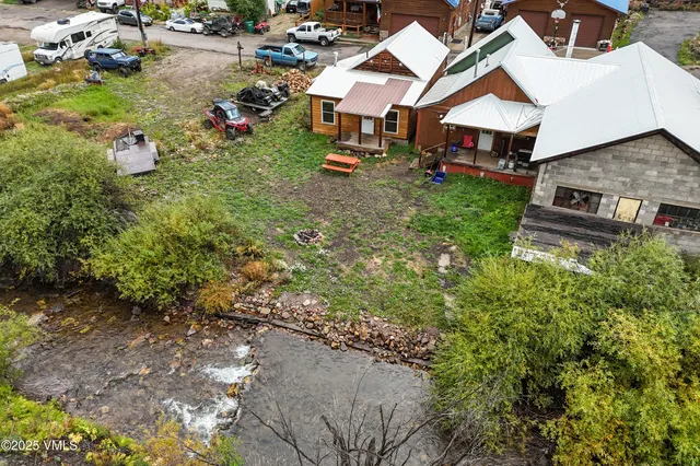 an aerial view of a house with a yard and lake view