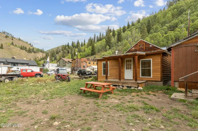 a backyard of a house with table and chairs