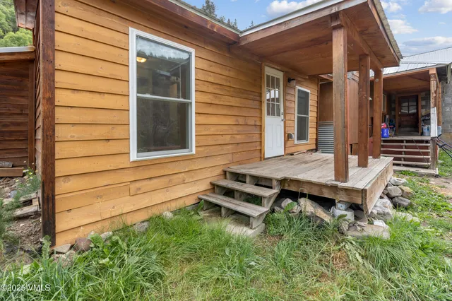 a backyard of a house with barbeque oven table and chairs