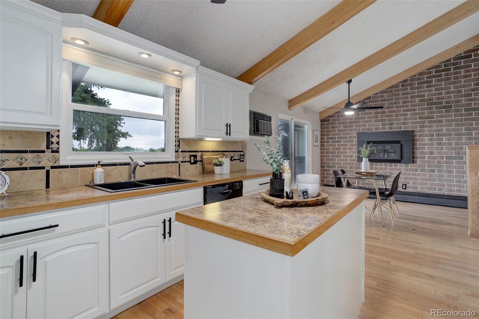 14650 Tejon Street Broomfield, CO 80023 - Photo 12 of 39 a kitchen with kitchen island granite countertop a sink appliances and cabinets