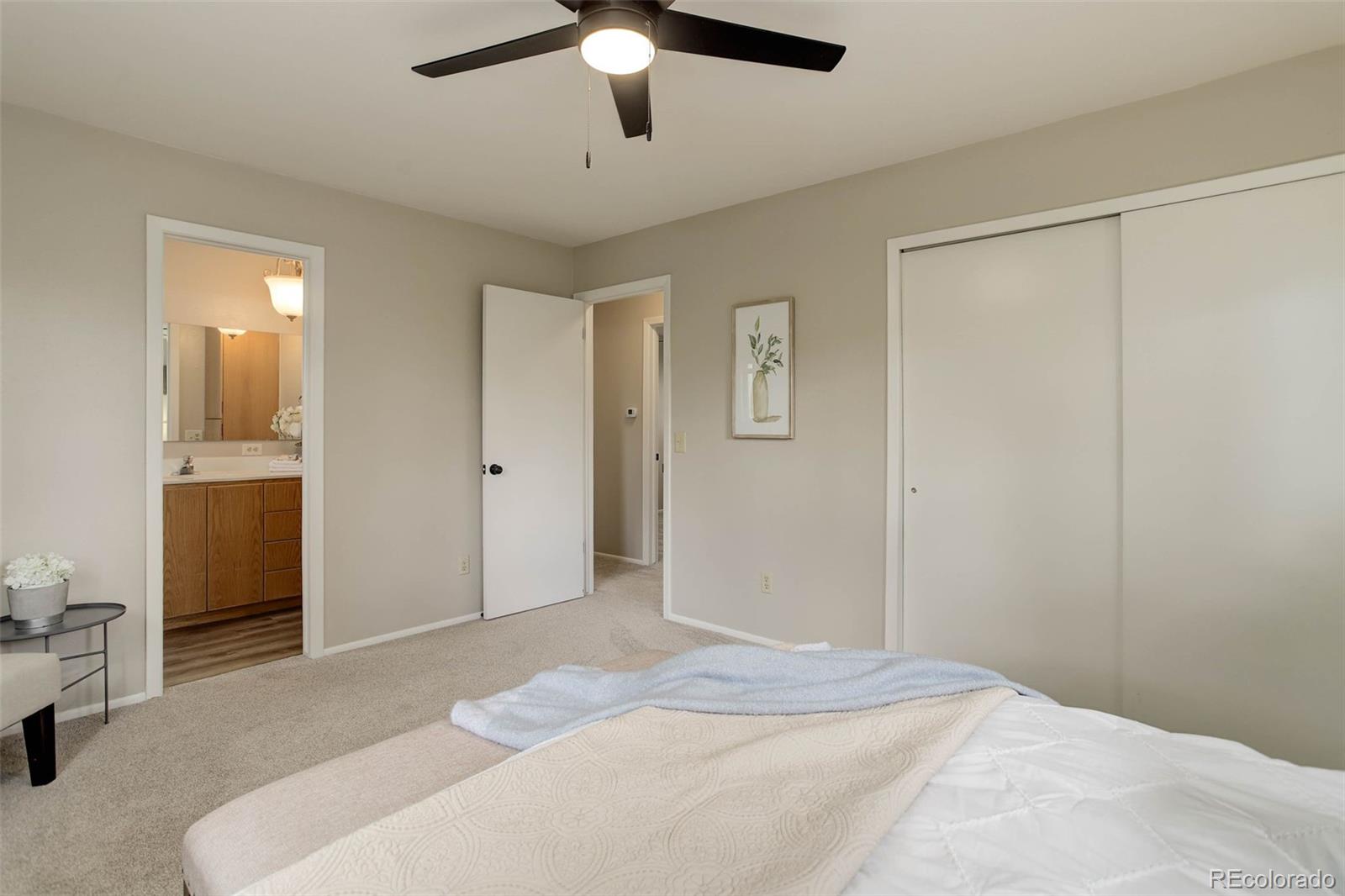 14650 Tejon Street Broomfield, CO 80023 - Photo 21 of 39 a bedroom with a bed and a chandelier