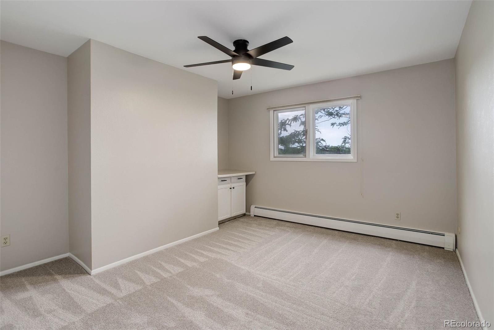 14650 Tejon Street Broomfield, CO 80023 - Photo 23 of 39 an empty room with windows and ceiling fan