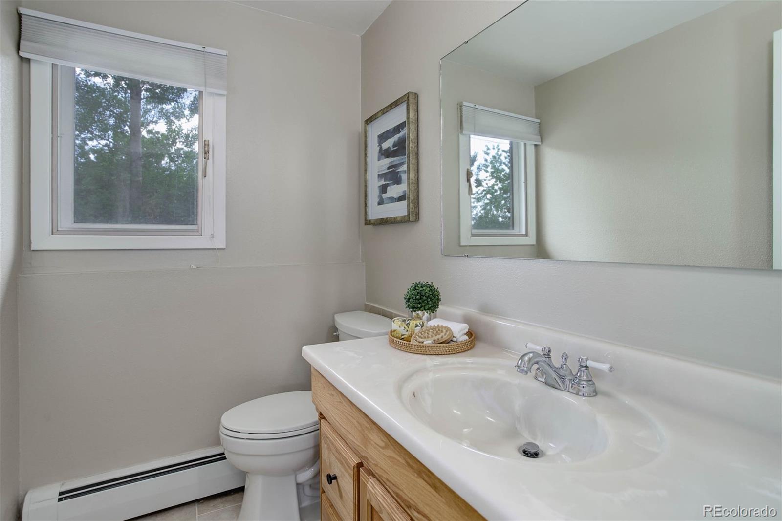 14650 Tejon Street Broomfield, CO 80023 - Photo 27 of 39 a bathroom with a sink mirror and toilet