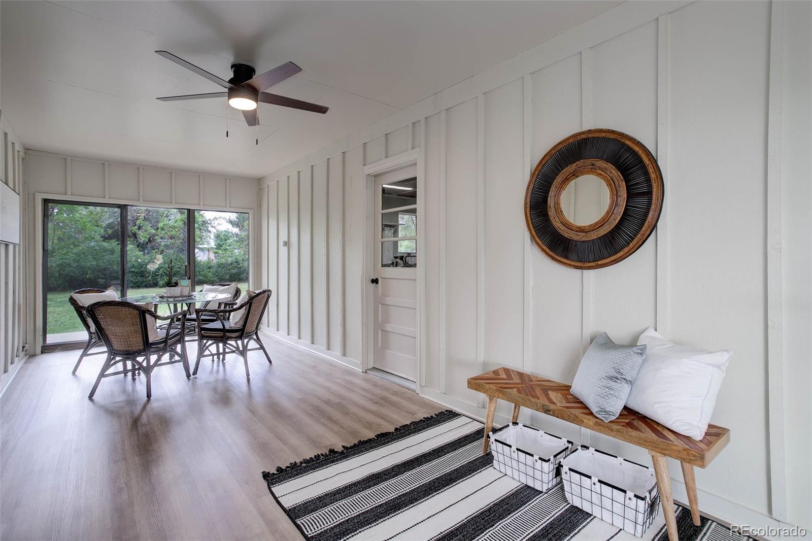 14650 Tejon Street Broomfield, CO 80023 - Photo 29 of 39 a dining room with furniture a chandelier and wooden floor