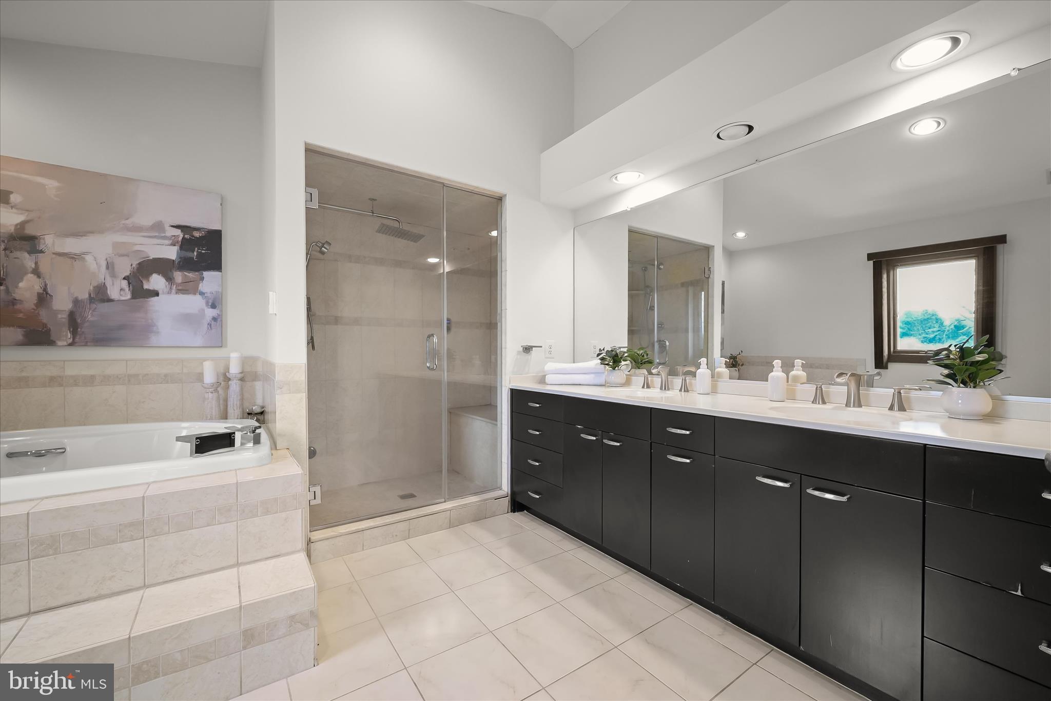 13304 Ridgewood Drive Ellicott City, MD 21042 - Photo 34 of 95 a spacious bathroom with a tub sink shower and mirror