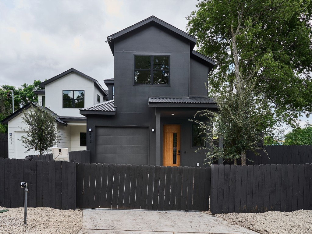 a front view of a house with a wooden fence