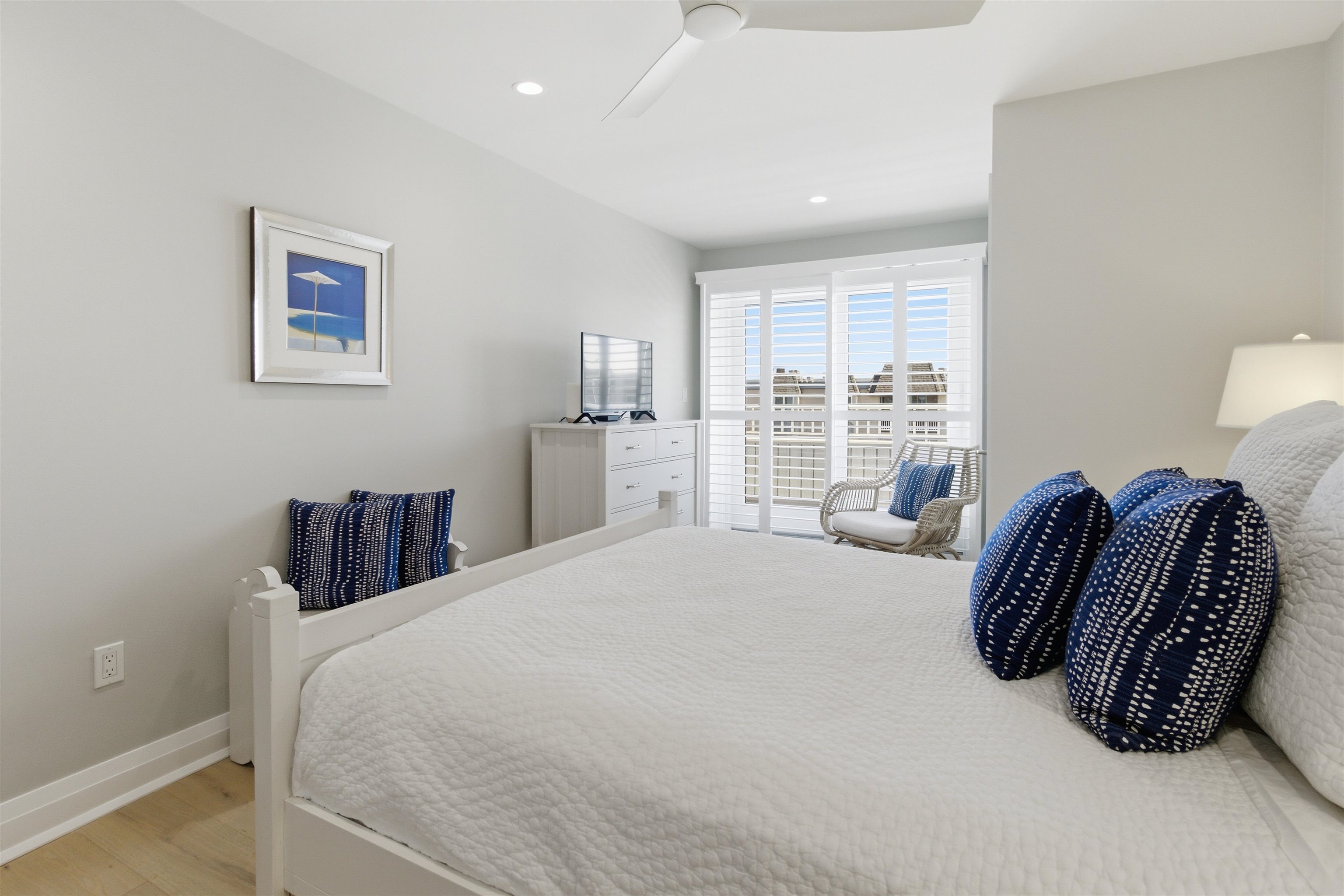 10803 3rd, Unit 6 Stone Harbor, NJ 08247 - Photo 21 of 25 a bedroom with a bed and a large window