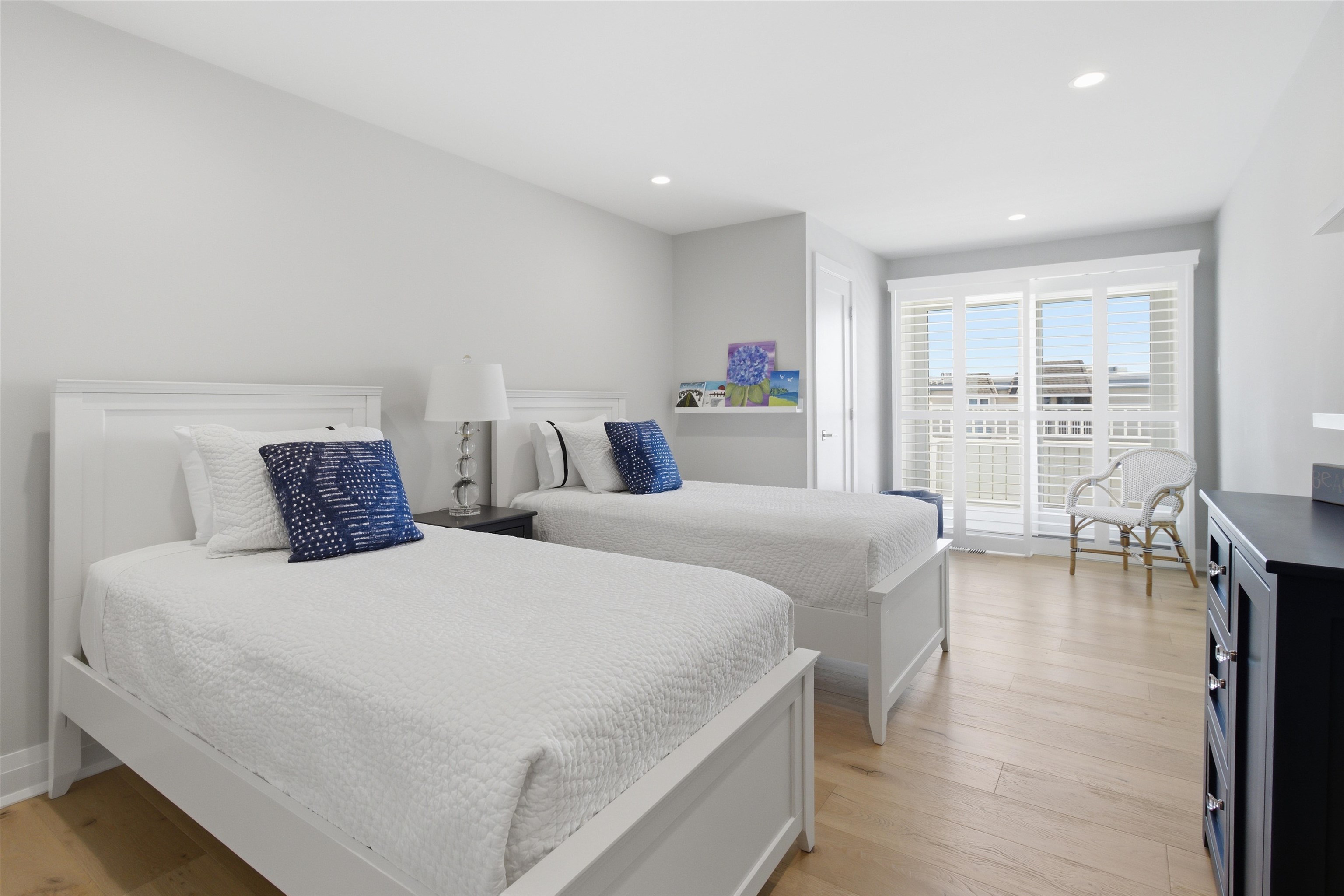 10803 3rd, Unit 6 Stone Harbor, NJ 08247 - Photo 22 of 25 a bedroom with two beds and a large window
