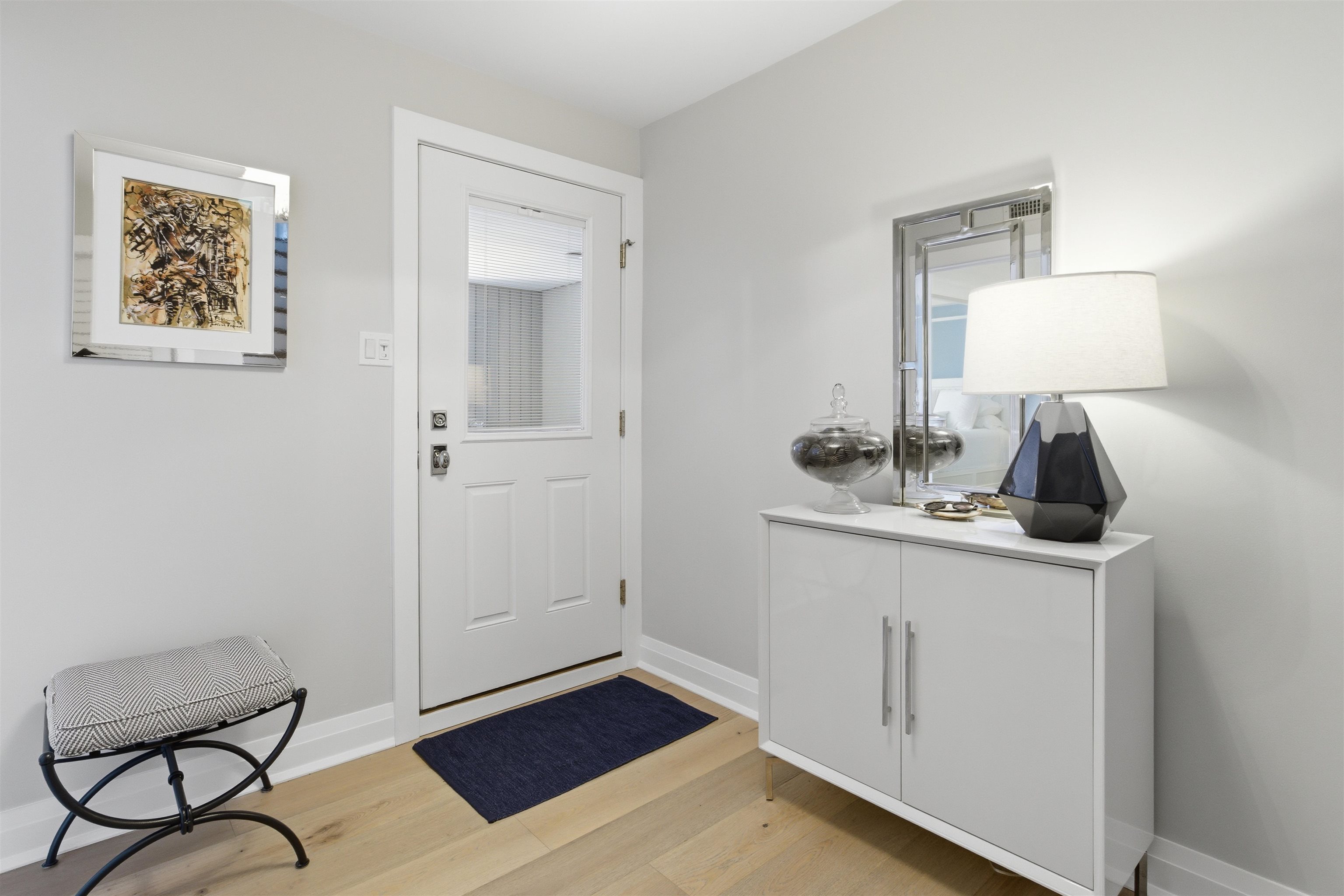 10803 3rd, Unit 6 Stone Harbor, NJ 08247 - Photo 4 of 25 a room with a sink and a mirror