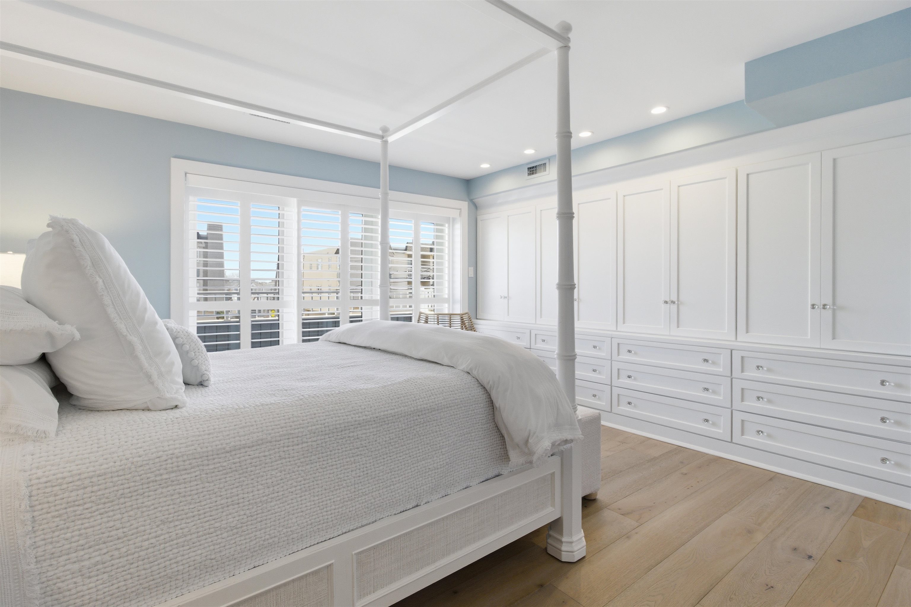 10803 3rd, Unit 6 Stone Harbor, NJ 08247 - Photo 6 of 25 a bedroom with a large bed and a large window