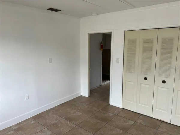 an empty room with closet area