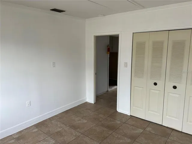 an empty room with closet area