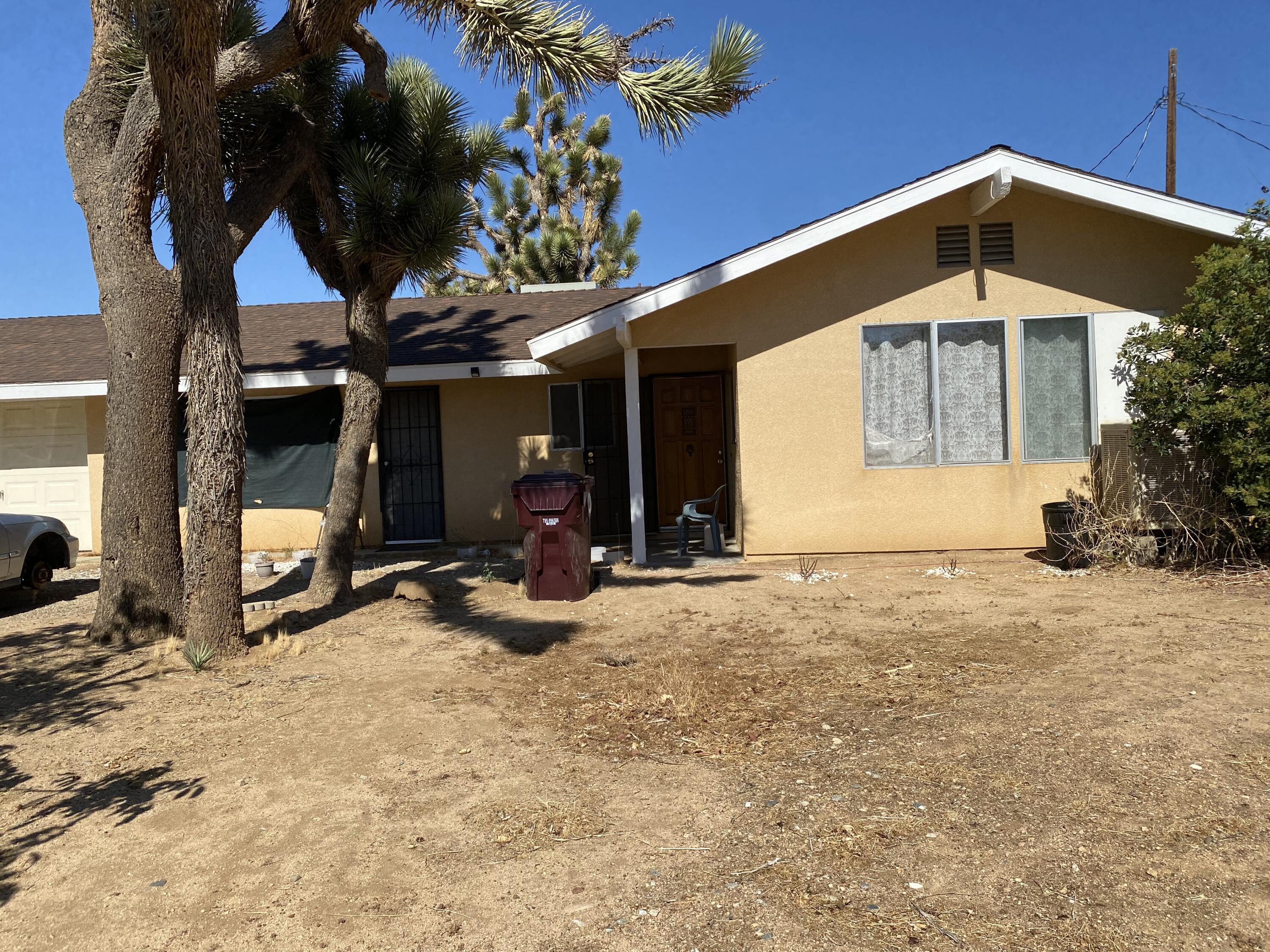 7865 Fox Trail Yucca Valley, CA 92284 - Photo 1 of 7 a view of a house with a yard