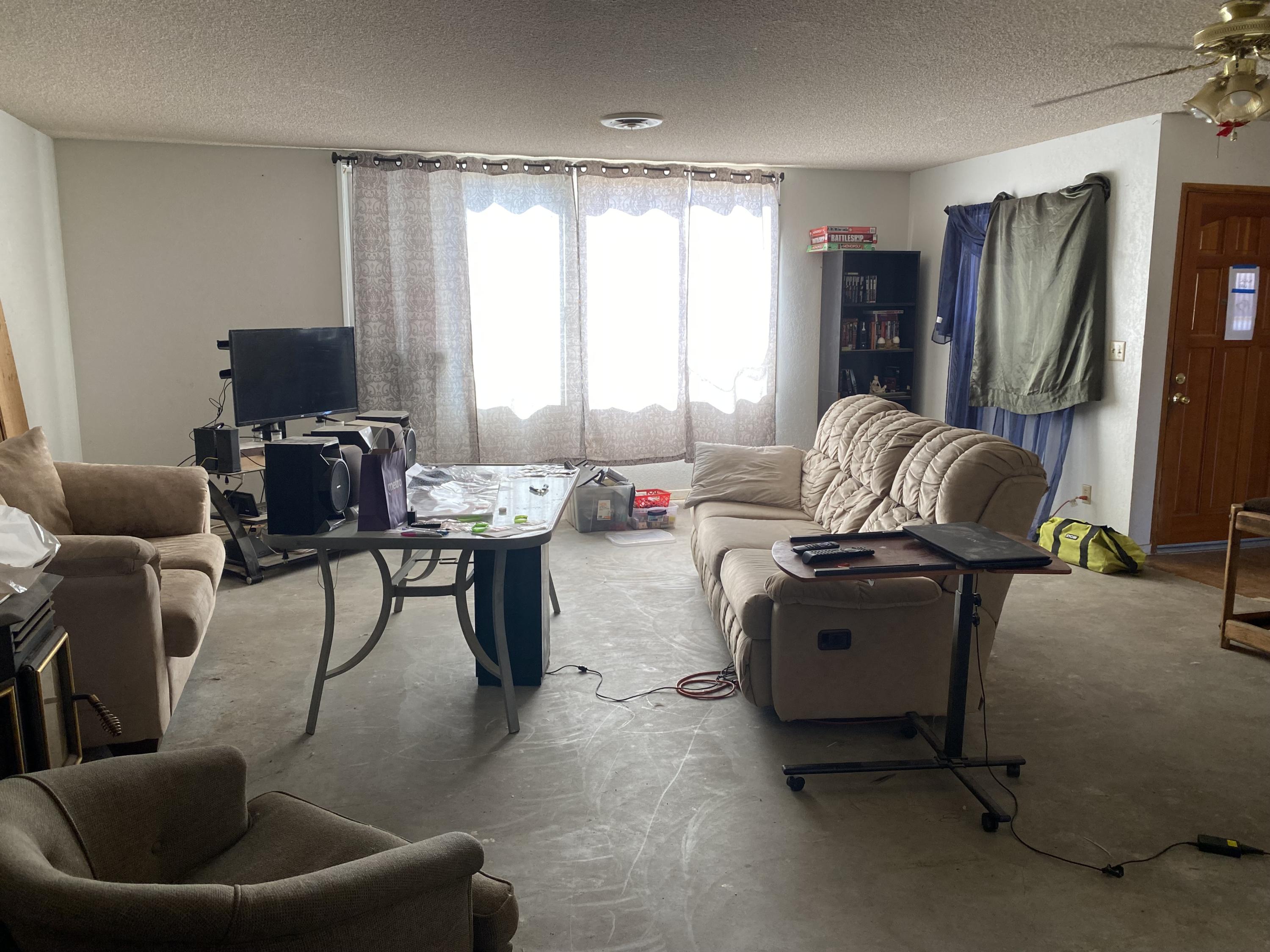 7865 Fox Trail Yucca Valley, CA 92284 - Photo 2 of 7 a living room with furniture and a flat screen tv