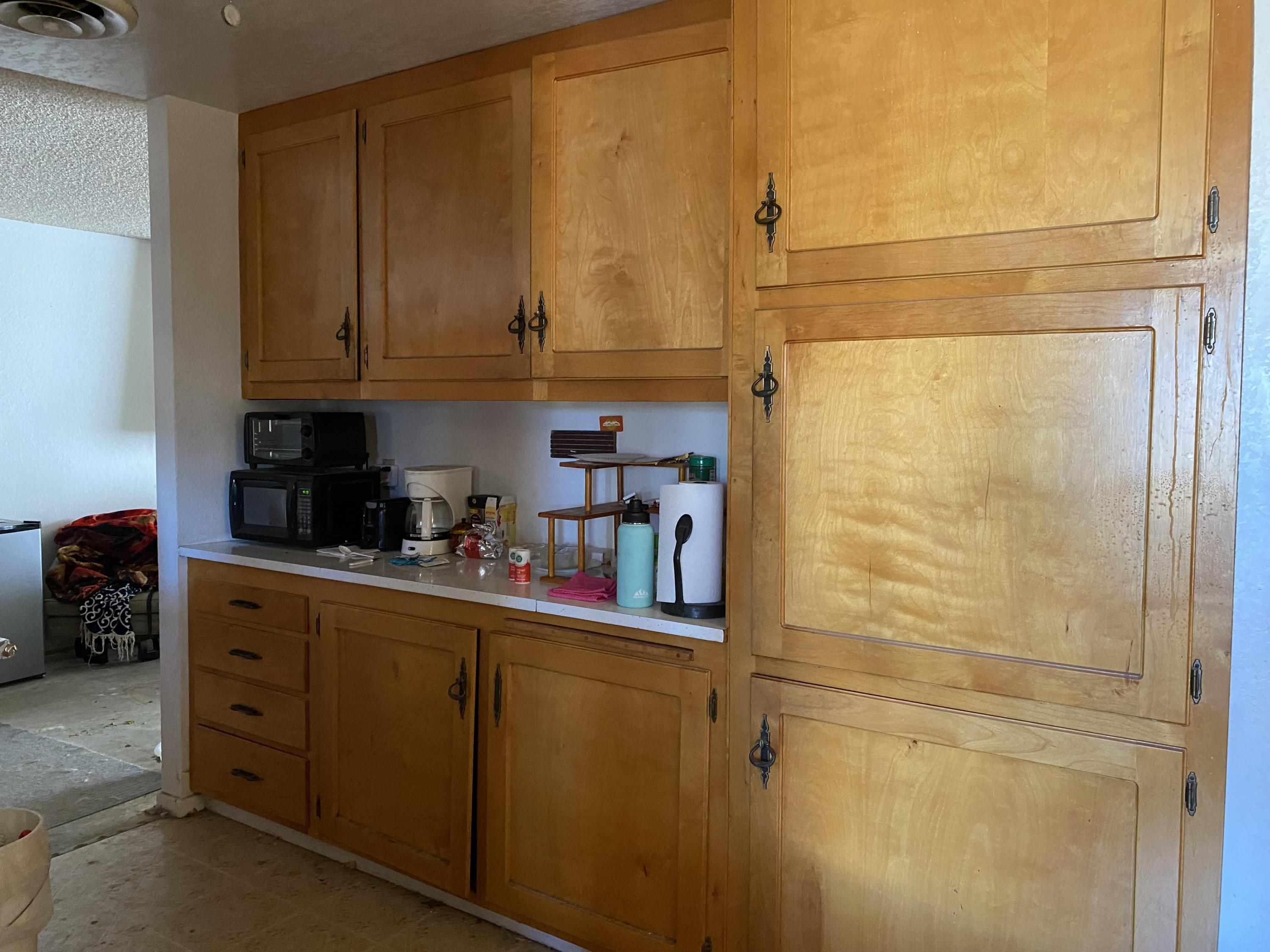 7865 Fox Trail Yucca Valley, CA 92284 - Photo 3 of 7 a kitchen with stainless steel appliances a refrigerator and cabinets