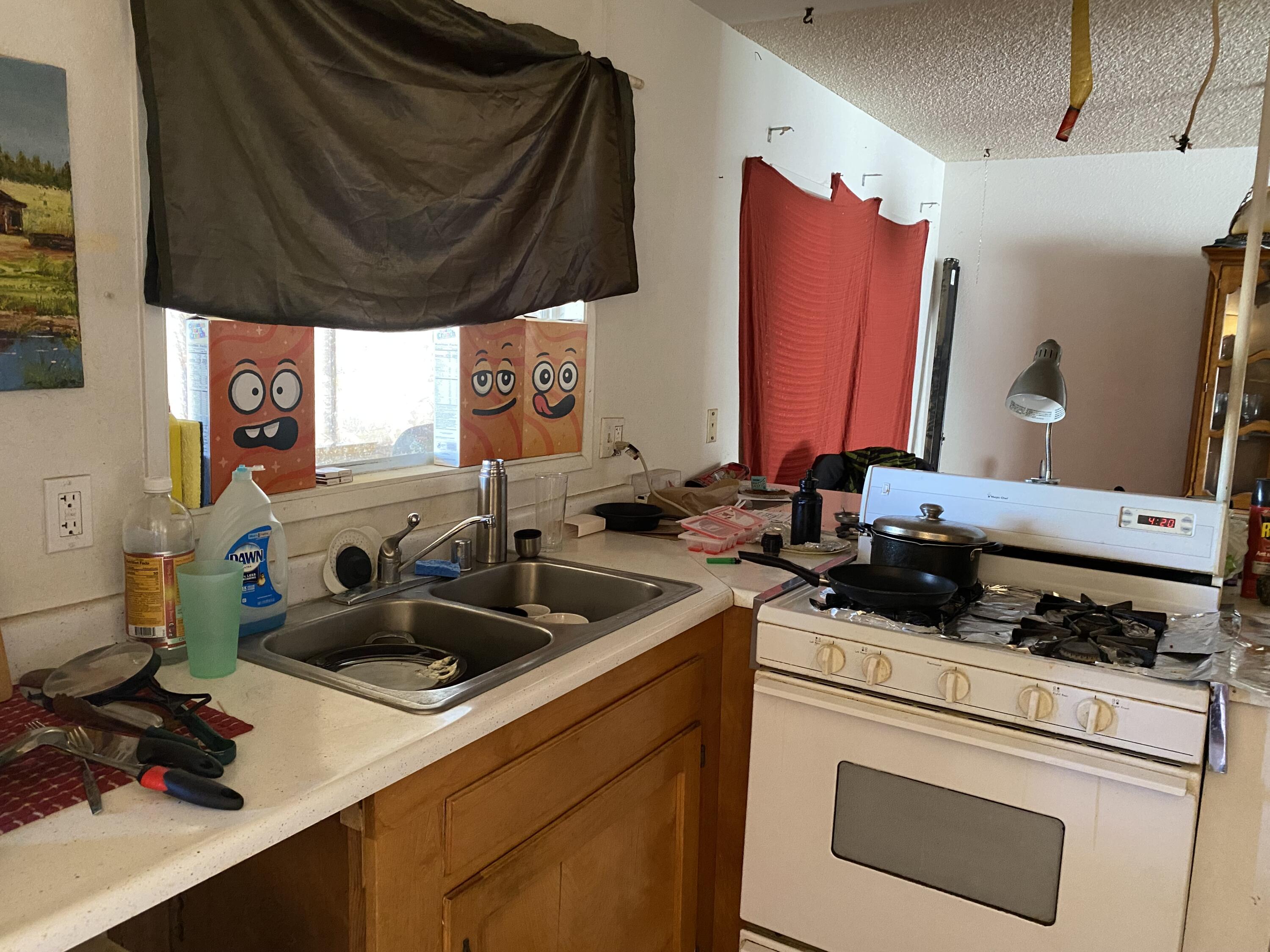 7865 Fox Trail Yucca Valley, CA 92284 - Photo 4 of 7 a kitchen with a sink a stove and a refrigerator