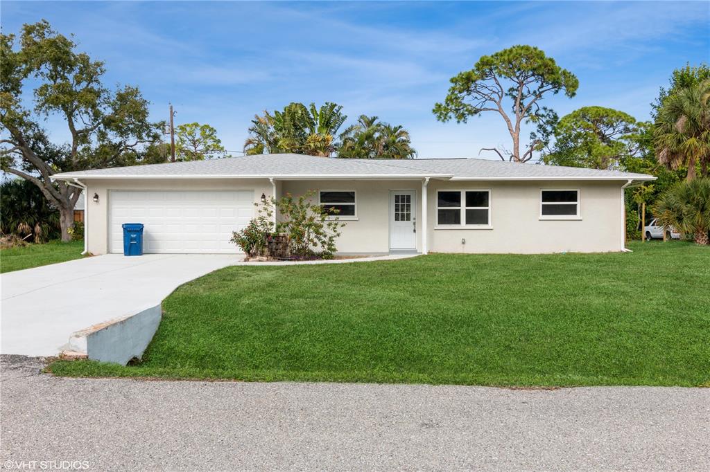 864 Gull Road Venice, FL 34293 - Photo 1 of 1 a front view of a house with a garden and plants