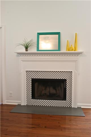Wood burning fireplace creates a focal point as you enter home.