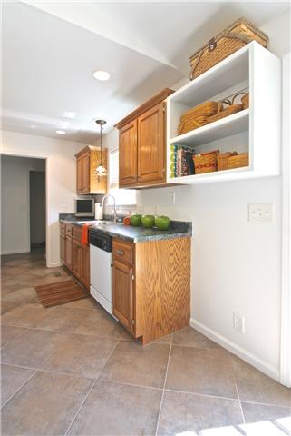 Light filled kitchen with tile floors.