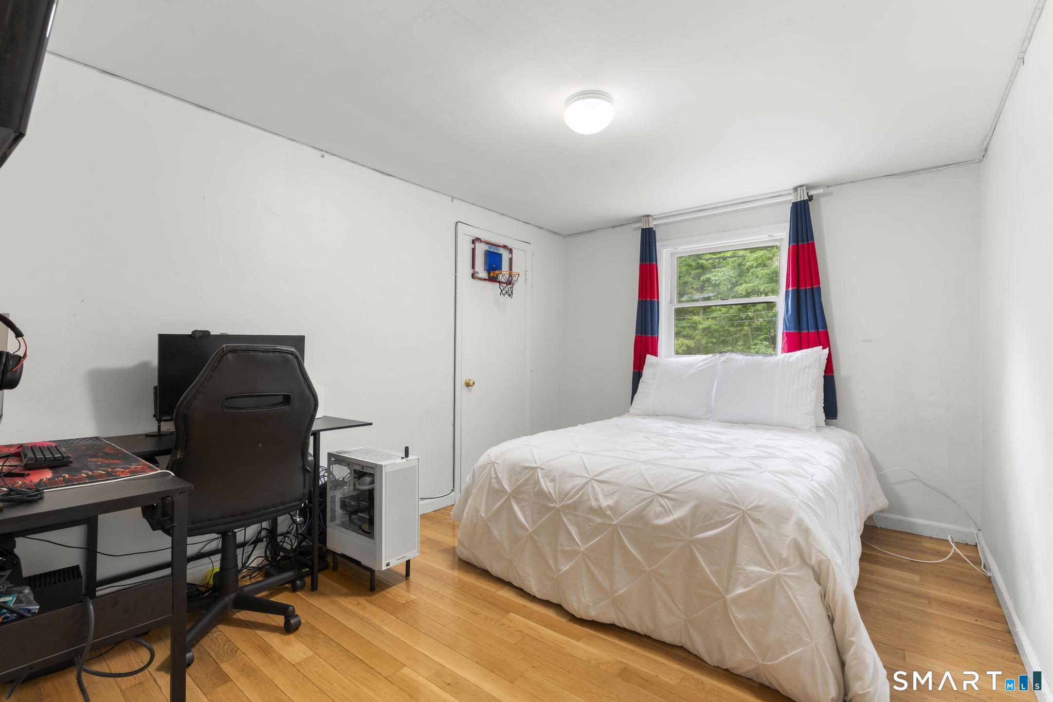 200 Old Huckleberry Road Wilton, CT 06897 - Photo 15 of 24 a bedroom with a bed and a desk