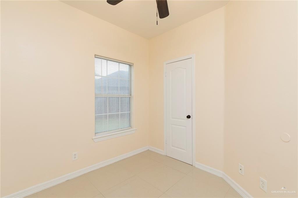 2001 Quail Lane Mission, TX 78572 - Photo 21 of 28 Neutral-toned interior room featuring tile flooring and light-colored walls