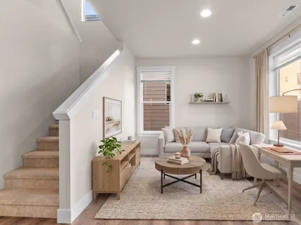 a living room with furniture potted plant and a window