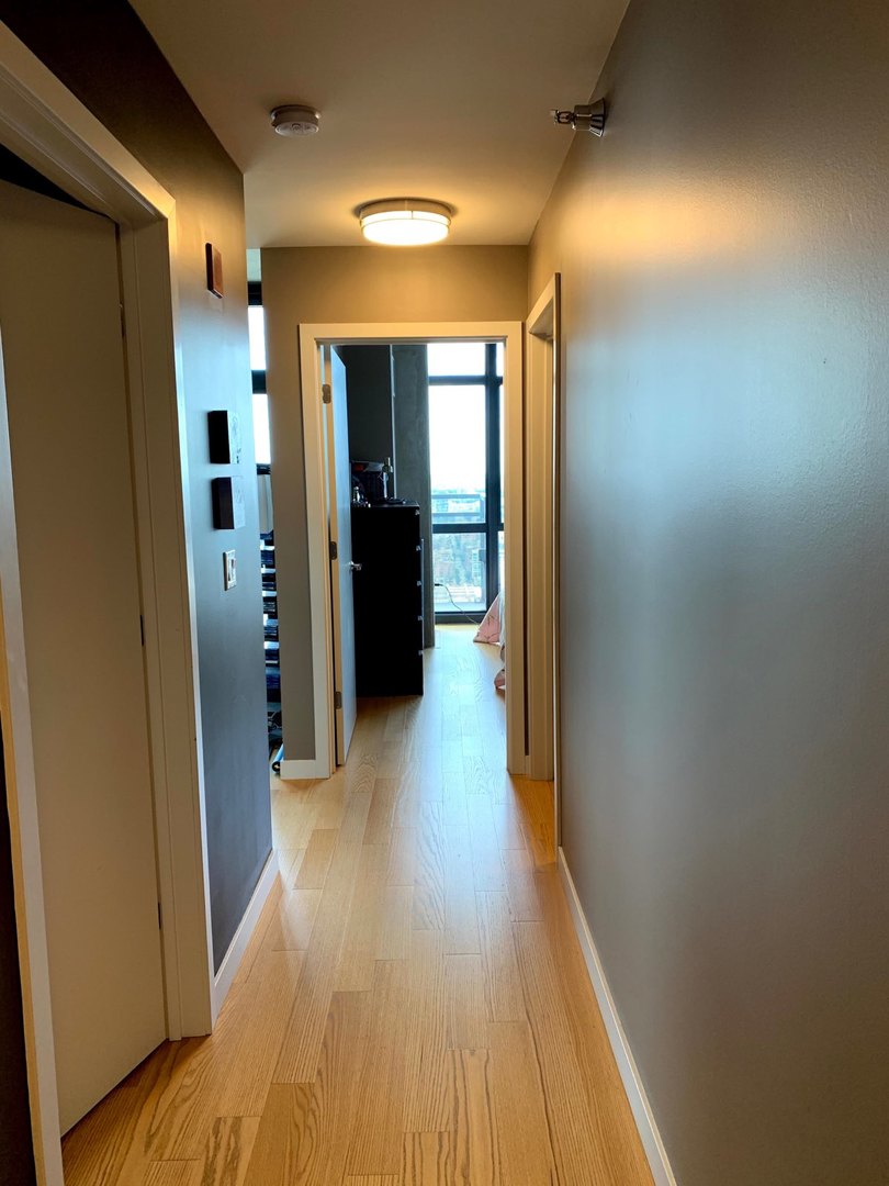 235 West Van Buren Street, Unit 4413 Chicago, IL 60607 - Photo 19 of 23 a view of hallway with wooden floor